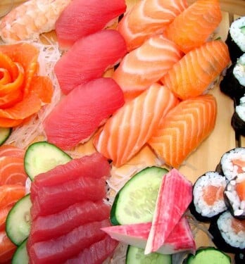An assortment of seafood include sushi and sashimi.