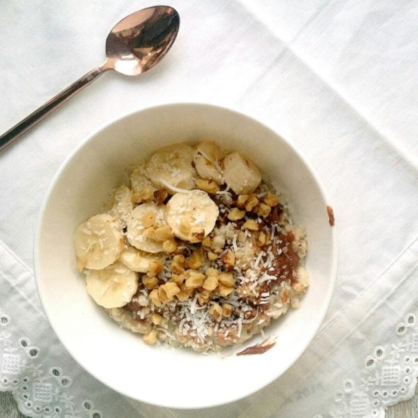 Chocolate Peanut Butter Oatmeal with Coconut, Walnuts, and Banana. Ingredients include quick oats, chocolate coconut peanut butter, shaved coconut, walnut pieces, banana slices.