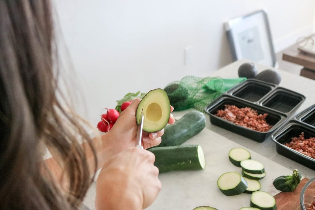 Lindsay Pleskot Registered Dietitian slicing an avocado