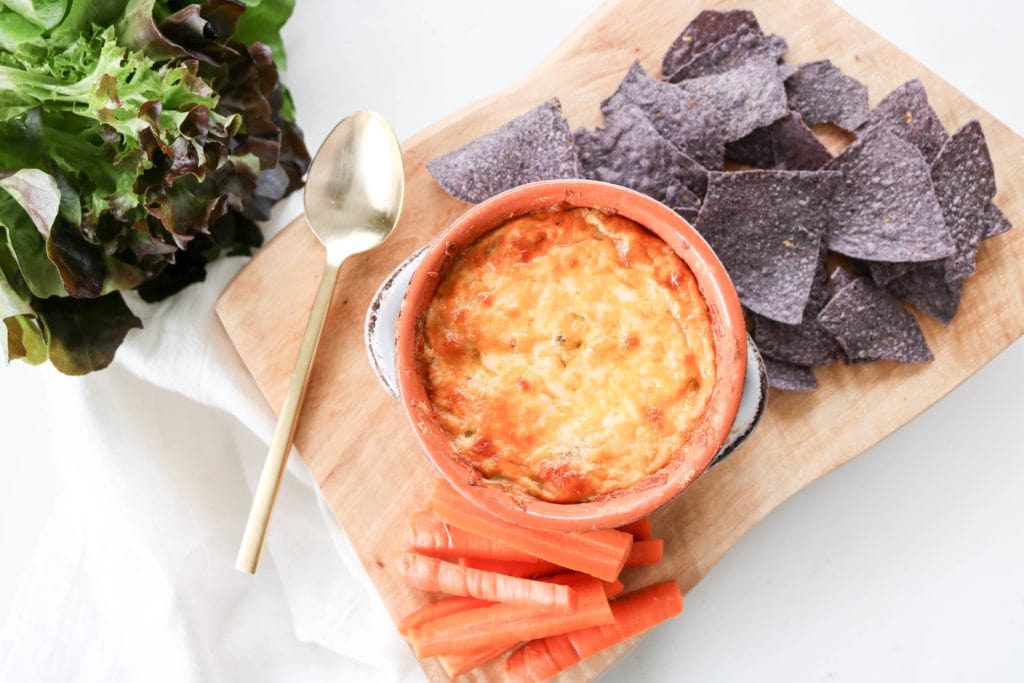  artichoke dip plated with carrots and tortilla chips
