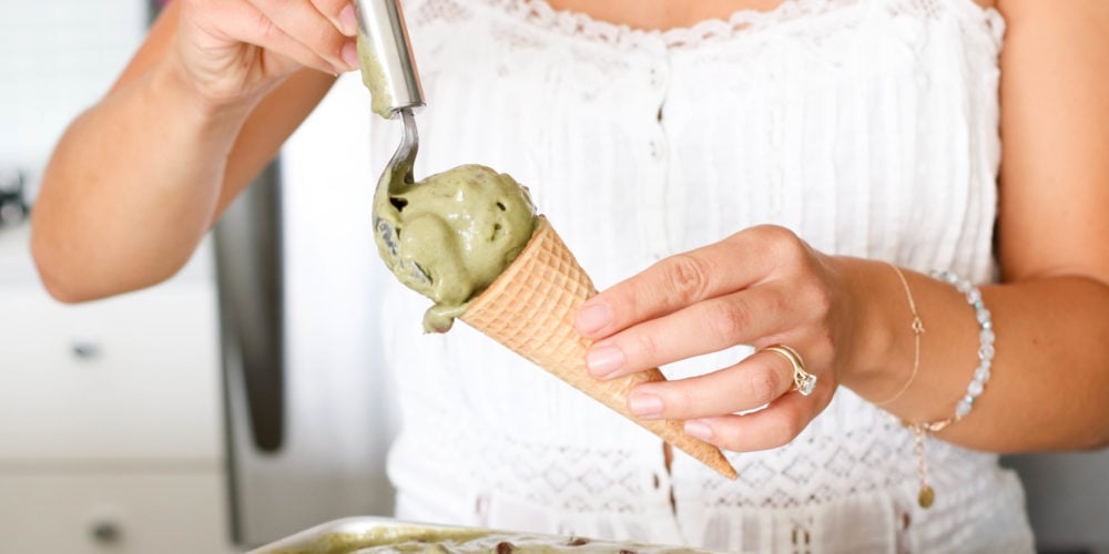 Registered Dieitian Lindsay Pleskot scooping ice cream into a cone. Ingredients include banana, mint, chocolate, greens.
