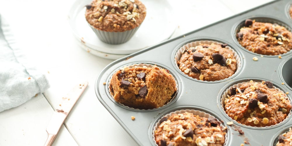 One bowl chocolate chip oat flour pumpkin muffins made with oat flour, pumpkin puree, creamy natural peanut butter, and chocolate chips.