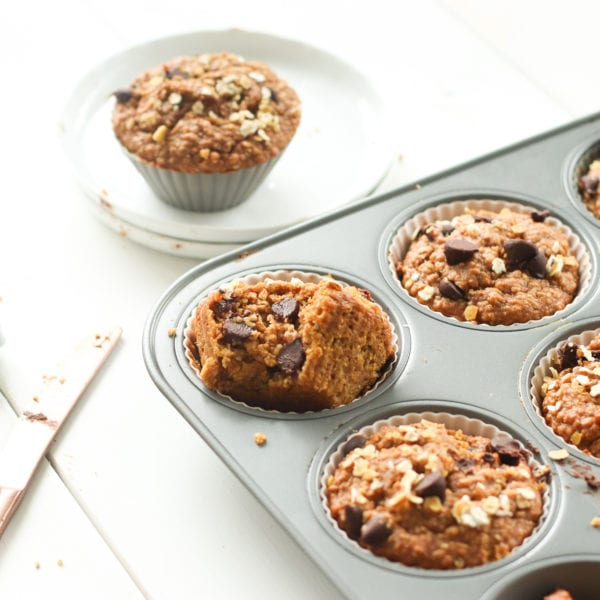 One bowl chocolate chip oat flour pumpkin muffins made with oat flour, pumpkin puree, creamy natural peanut butter, and chocolate chips.