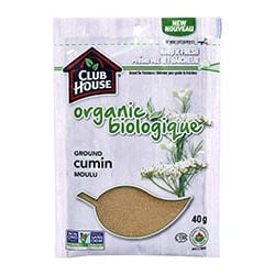 Organic ground cumin on a white background