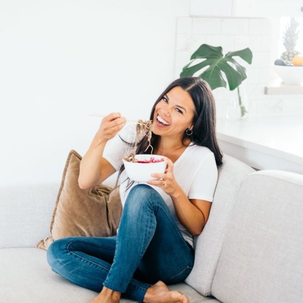Registered Dietitian Lindsay Pleskot eating mindfully on a couch