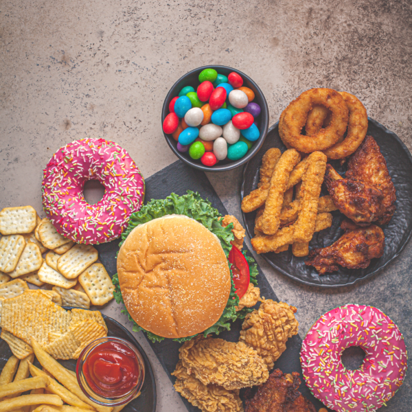 a photo of onion rings, donuts, burgers and fries.