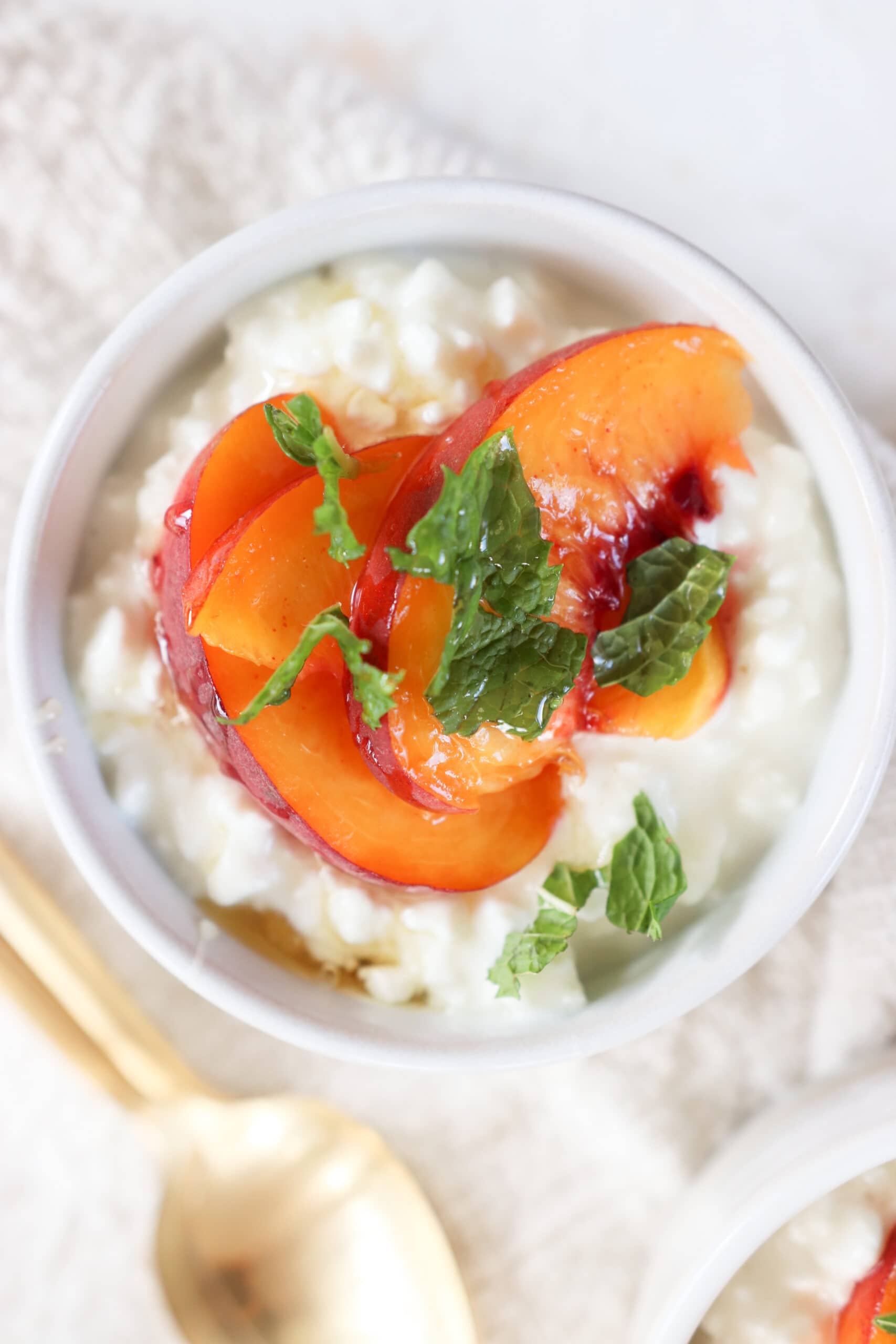 https://www.lindsaypleskot.com/wp-content/uploads/2023/08/cottage-cheese-and-fruit-in-a-bowl-topped-with-mint-scaled.jpg