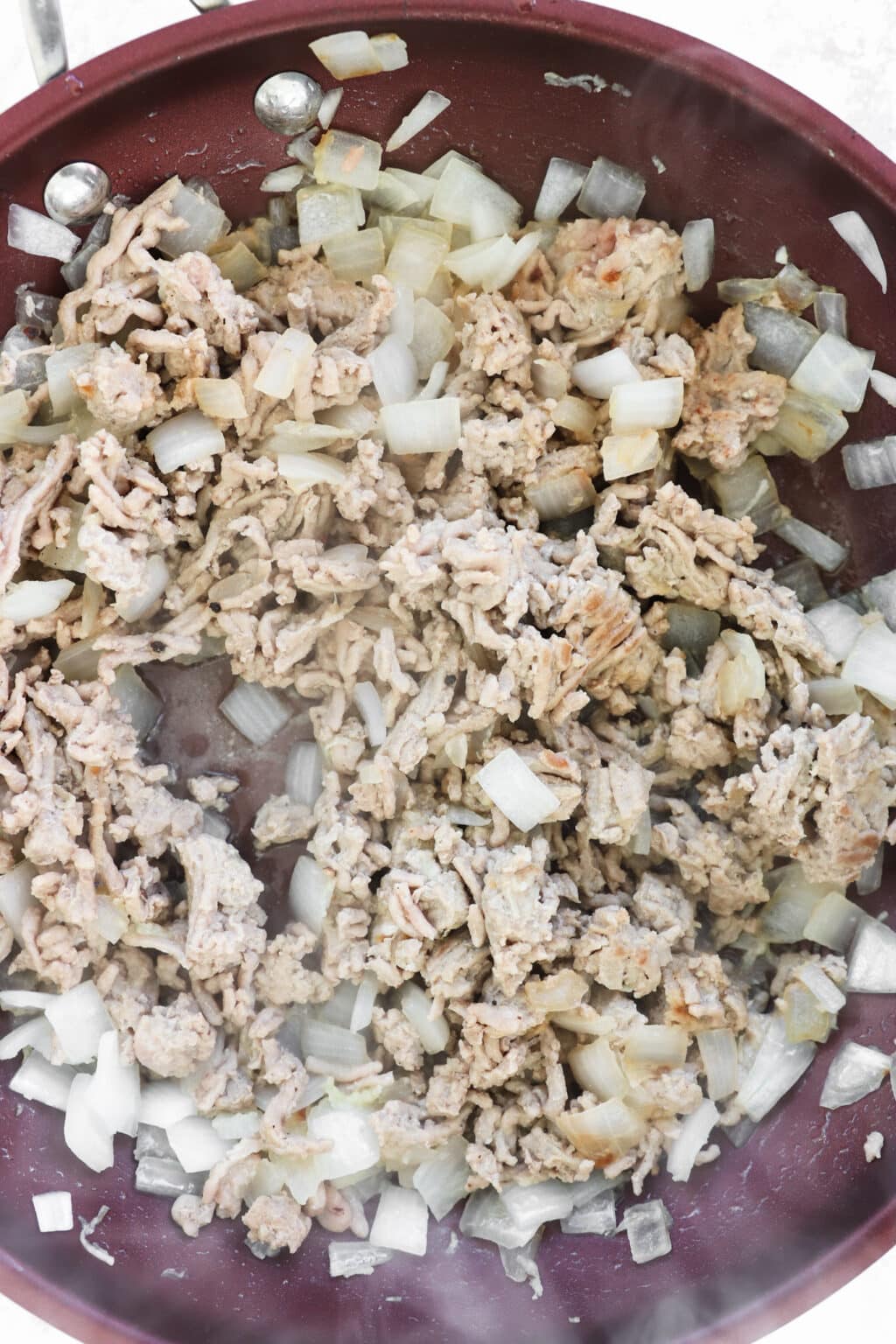 Ground turkey in a frying pan for a slow cooker sweet potato & turkey chili