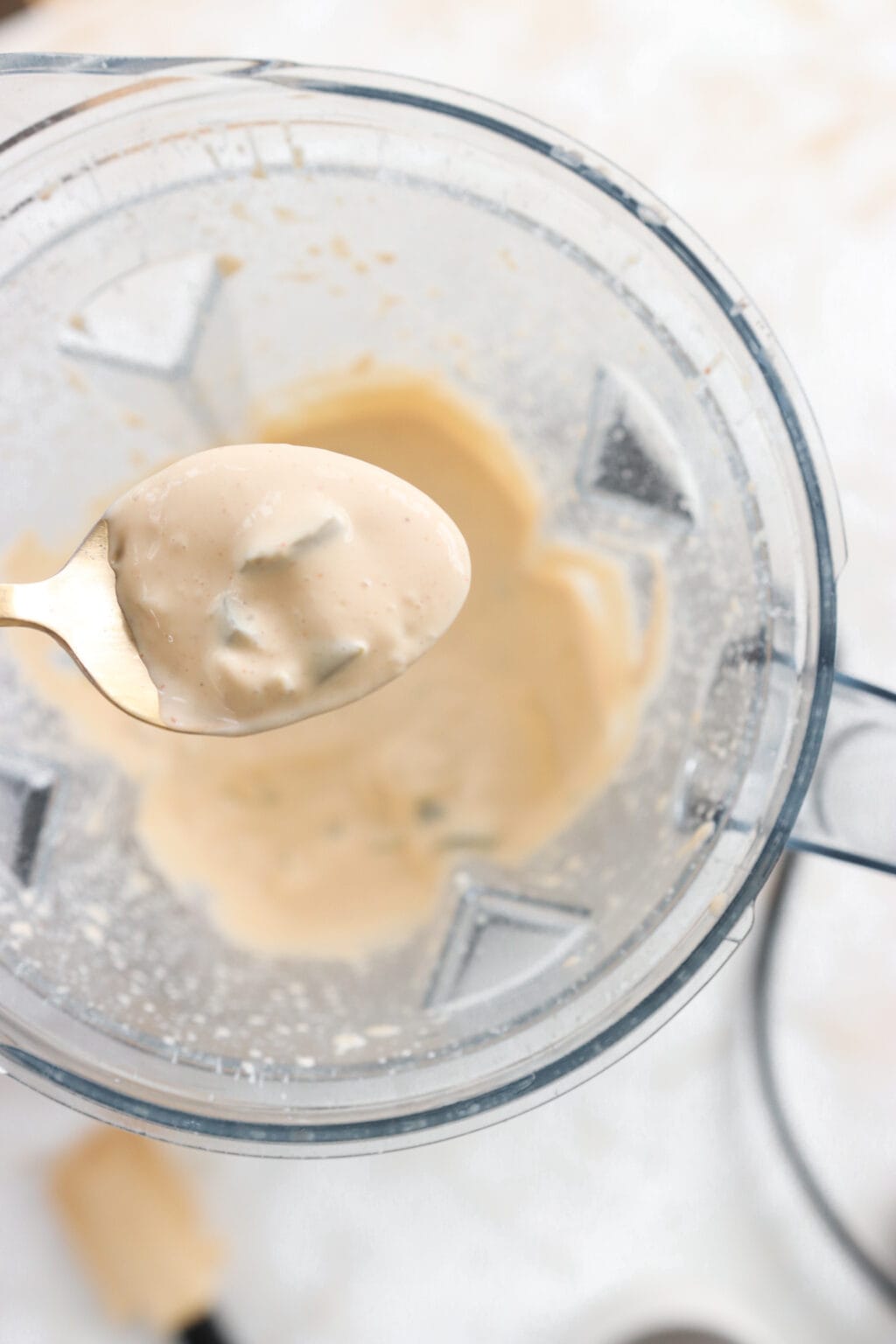 Ingredients for 5-Minute Warm Queso Dip With Cottage Cheese blended in a blender, including, cottage cheese, shredded tex mex cheese, taco seasoning, pickled jalapenos