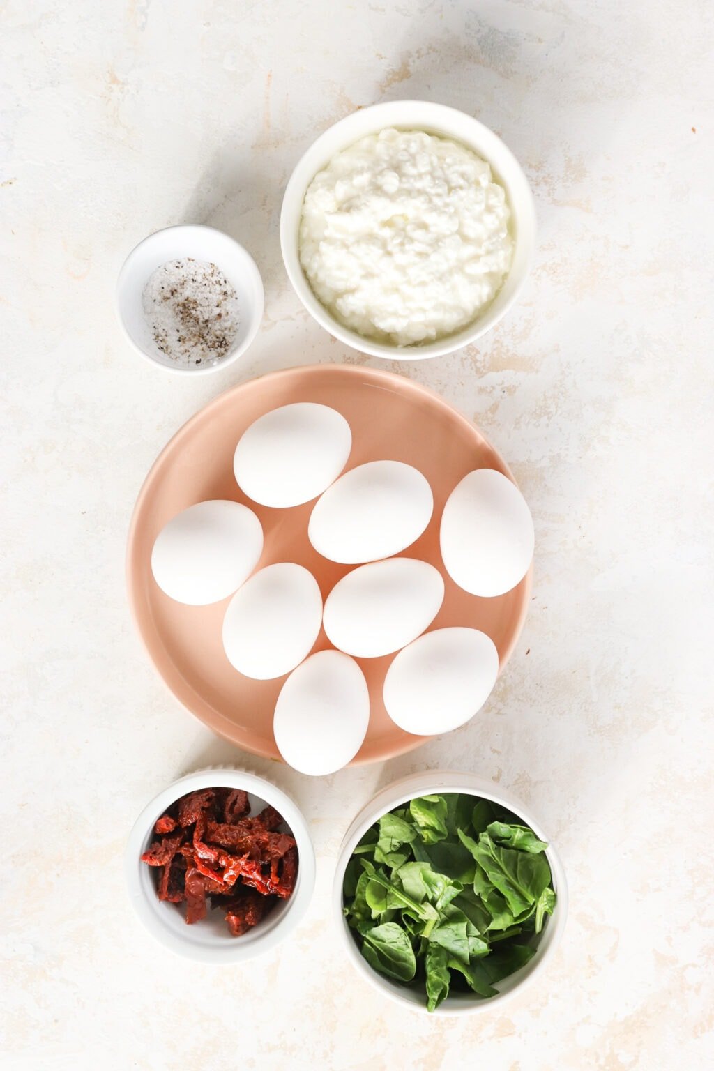 Ingredients for Egg Bites with Cottage Cheese, Spinach & Sun-dried Tomatoes, including eggs, cottage cheese, salt and pepper, spinach, sun-dried tomatoes