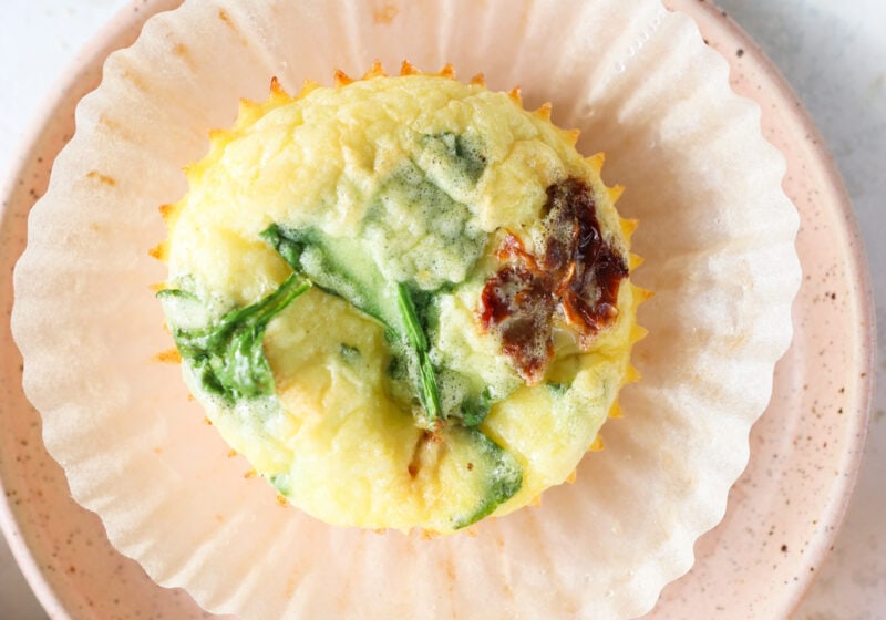 Egg Bites with Cottage Cheese, Spinach & Sun-dried Tomatoes on a pink plate