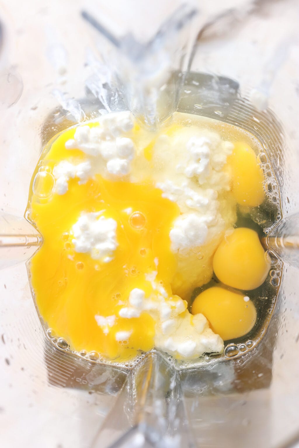 Eggs and cottage cheese in a blender for the Egg Bites with Cottage Cheese, Spinach & Sun-dried Tomatoes recipe