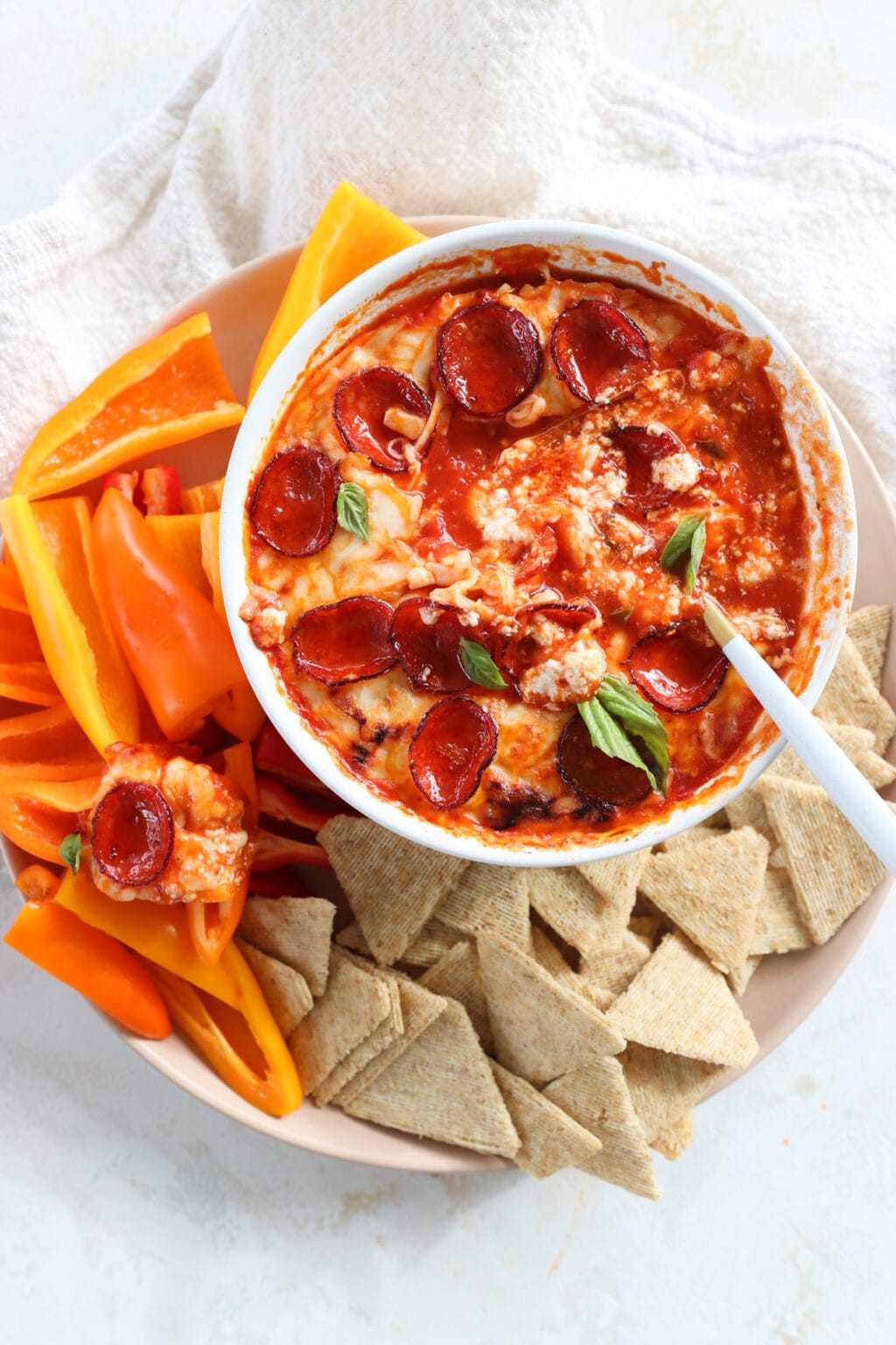 Quick Baked Cottage Cheese Pizza Bowl Dip in a white dish with peppers and chips on the side