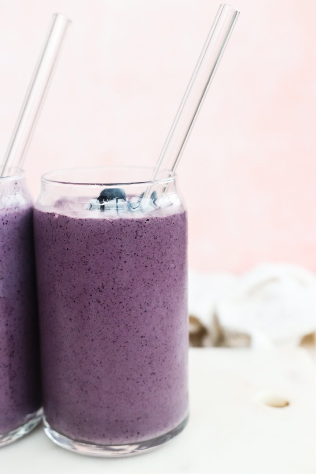 Two clear glasses filled with High Protein Blueberry Breakfast Smoothie with Cottage Cheese