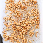 Uncooked prep ahead roasted cajun spice white beans on a baking sheet lined with parchment paper
