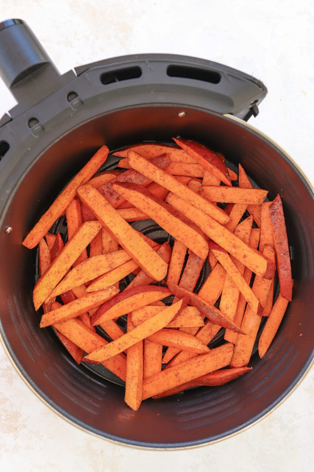 4 Ingredient Crispy Air Fryer Sweet Potato Wedges in an air fryer tray