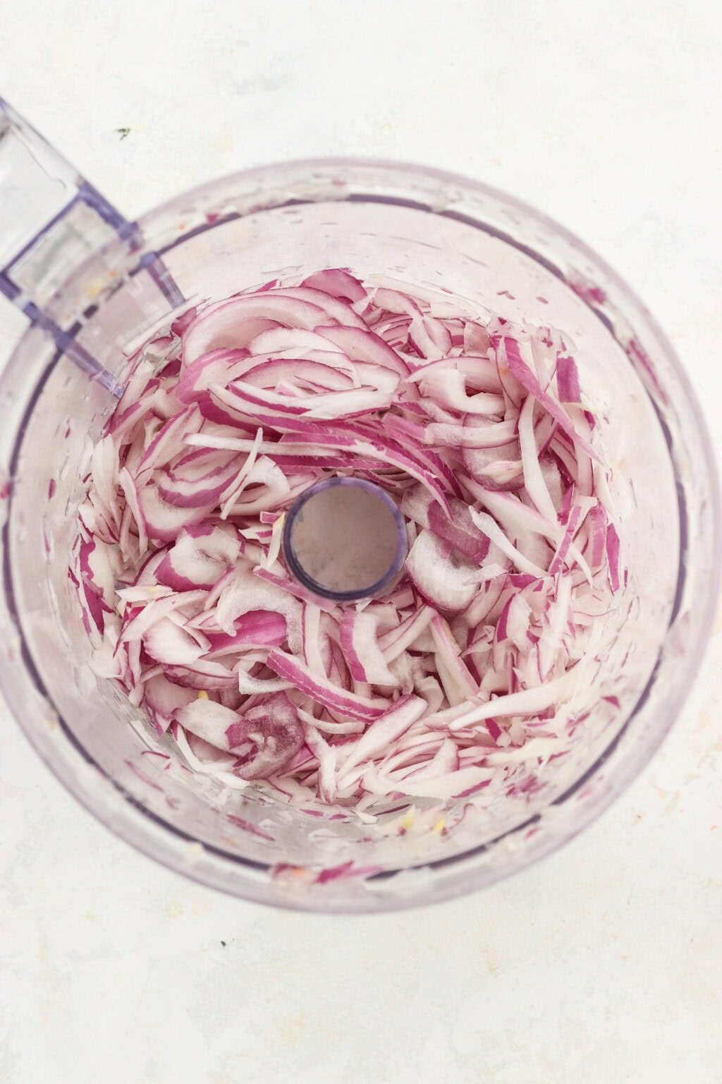 Shredded red onions in a food processor