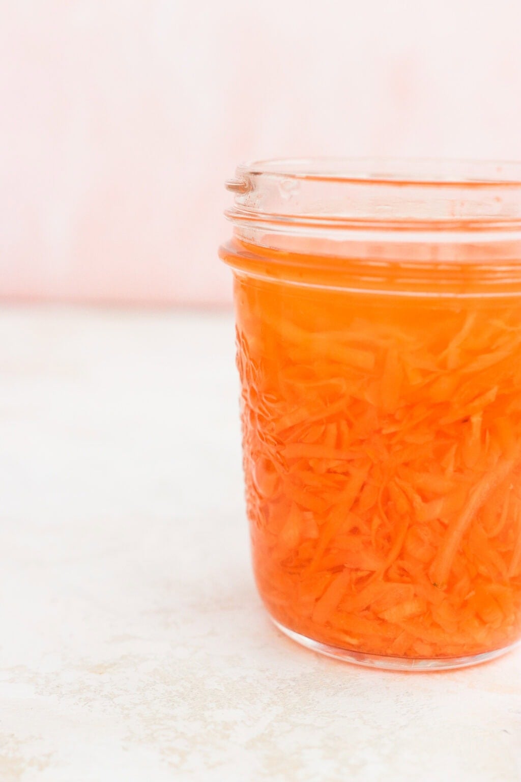 Quick pickled shredded carrots in a glass jar
