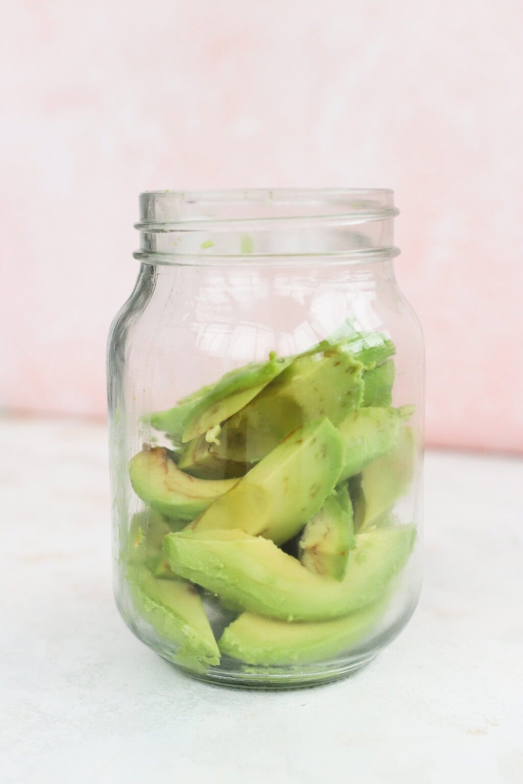 Quick pickled avocados in a glass jar