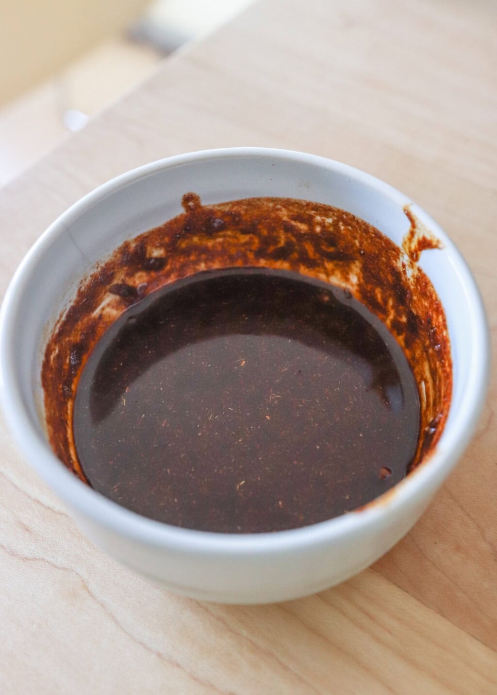 Mixed up marinade for 30 Minute Sheetpan Shrimp Fajitas in a small white bowl