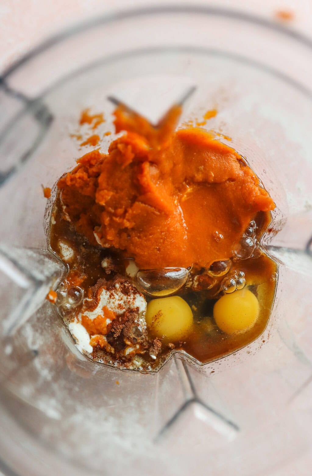 Unblended ingredients in a blender for Easy Oat Flour Pumpkin Bread with Chocolate Chips