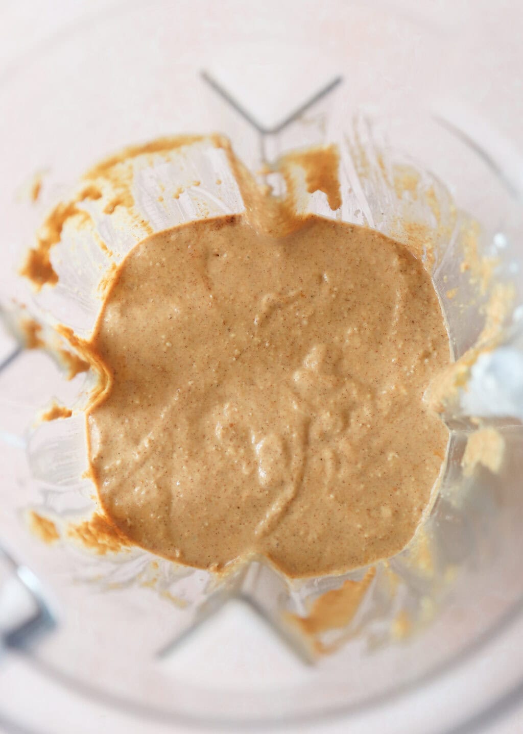 Ingredients for High Protein Pumpkin Pancakes with Cottage Cheese blended in a blender, including quick oats, pumpkin puree, cottage cheese, milk, eggs, baking powder, maple syrup, pumpkin pie spice, avocado oil