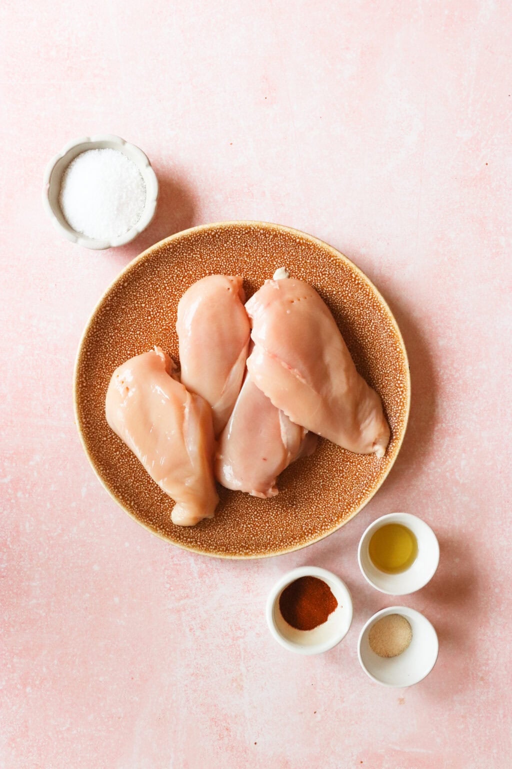 Ingredients for Juicy Thin Cut Chicken Breast, including chicken breasts, salt, pepper, paprika, garlic powder, and avocado oil.