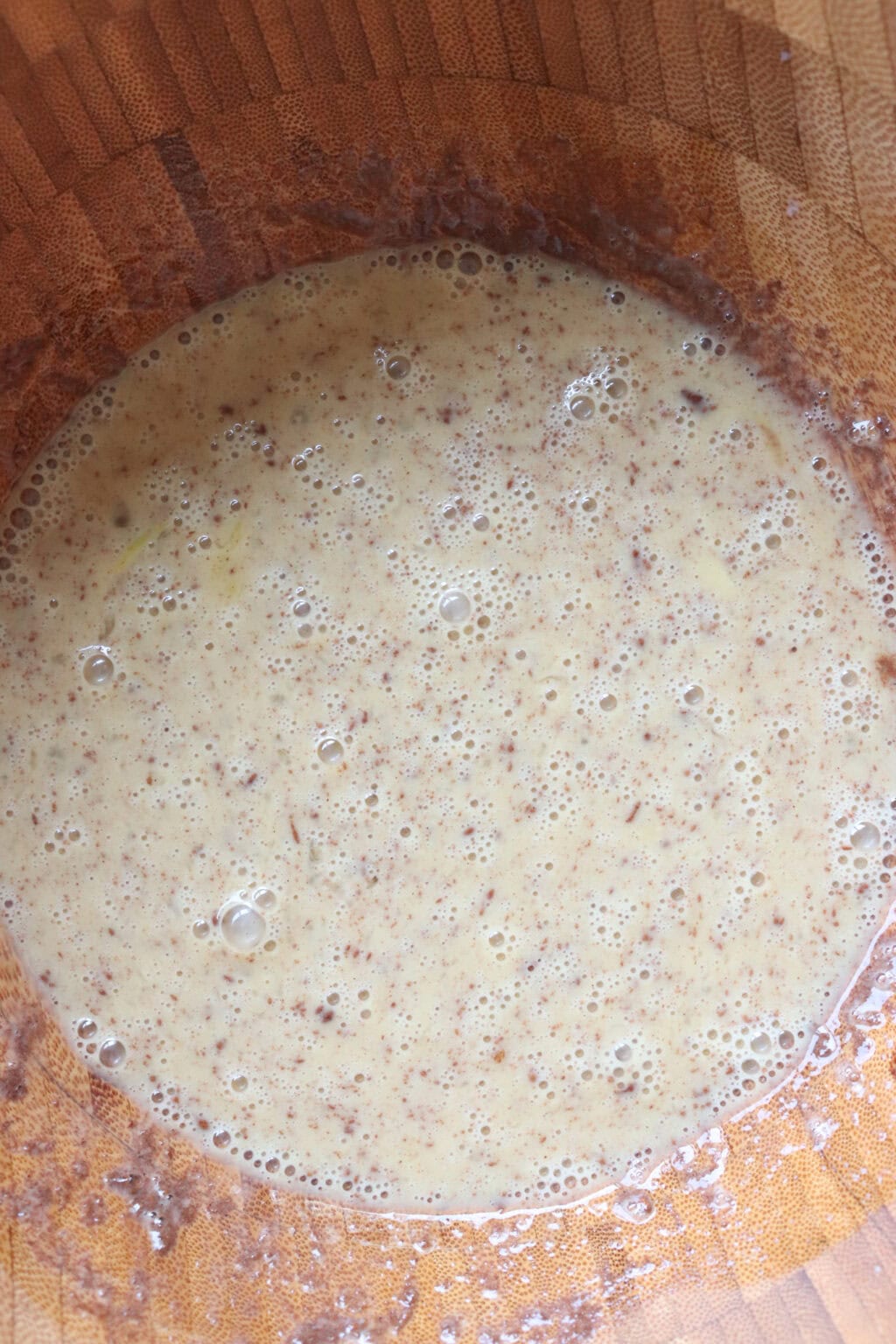 egg mixture for the sheet pan french toast recipe in a wooden bowl