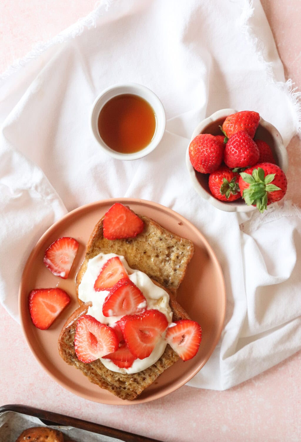 final product of sheet pan french toast with whipped greek yogurt and strawberries on top