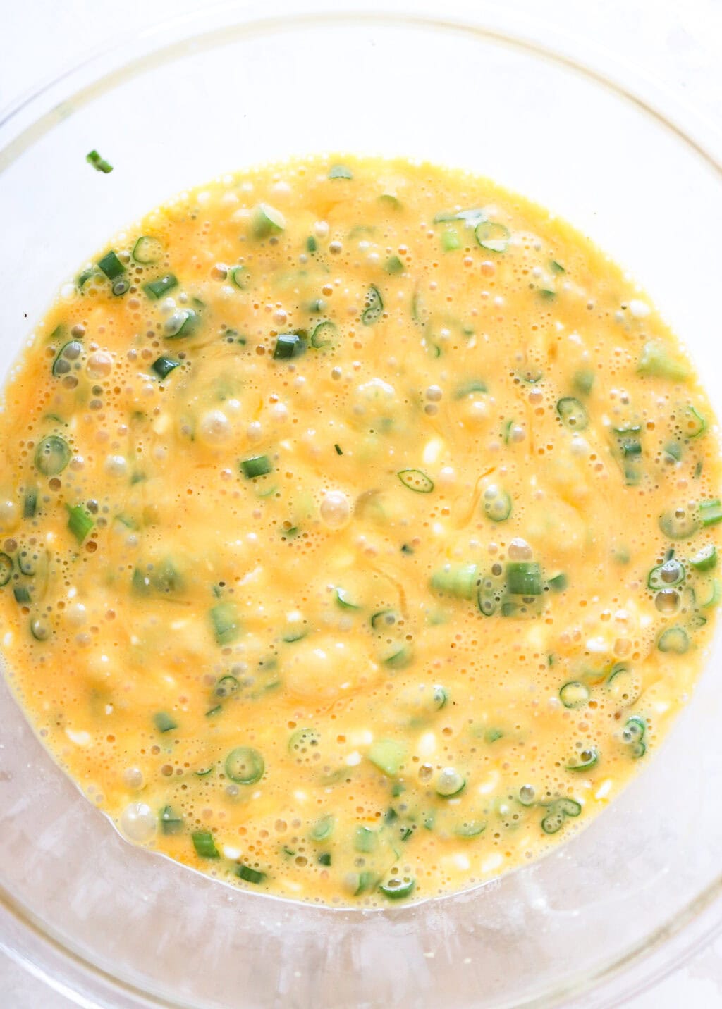 all ingredients in a glass bowl for the Egg and Cottage Cheese Breakfast Bake