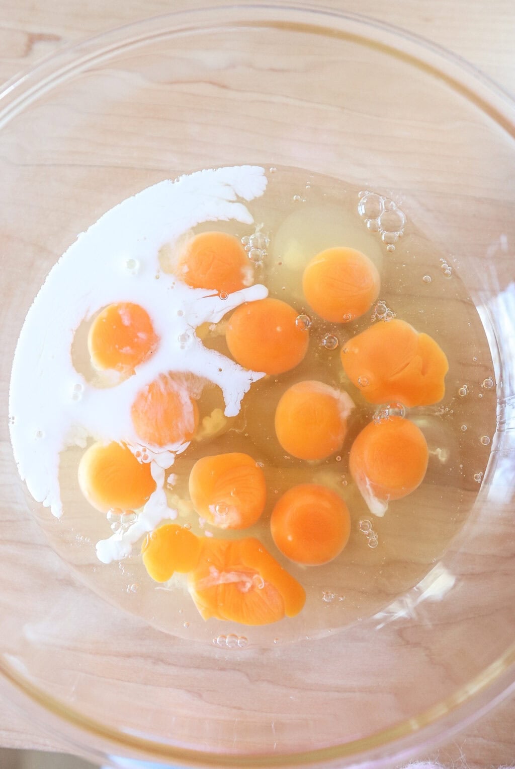 eggs and milk in glass bowl before being mixed
